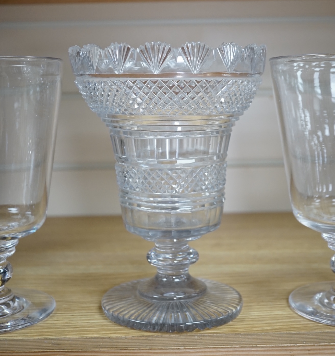 A Regency cut glass vase and a near pair of celery vases, largest 21cm high. Condition - good